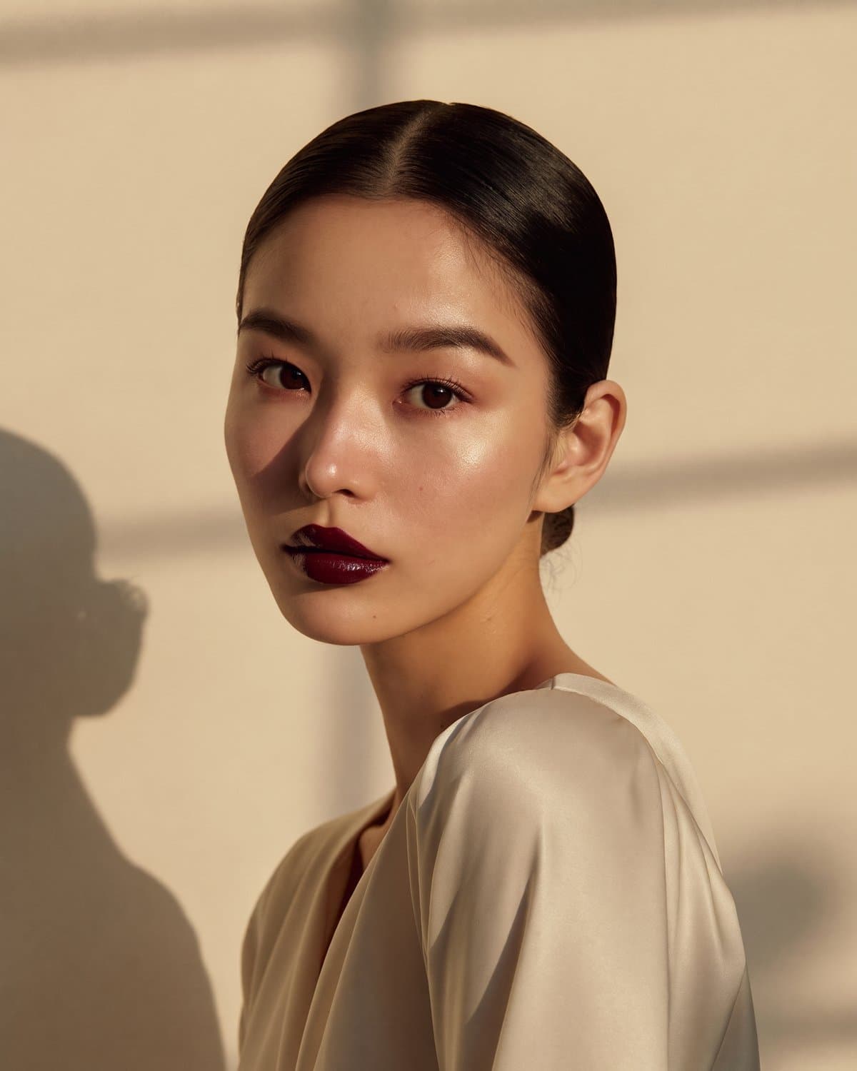 Editorial beauty portrait โ sleek hair, garnet lip